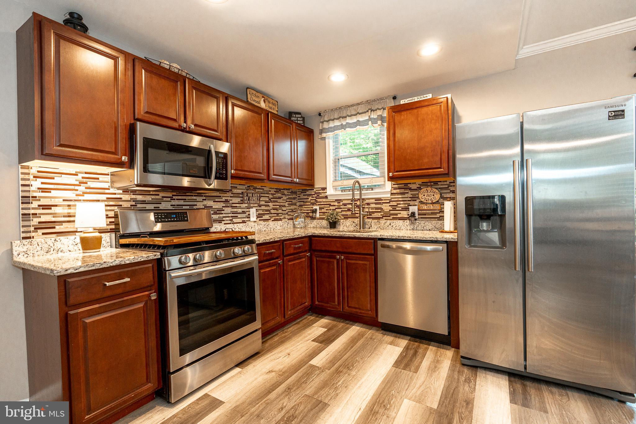 220 Pinewood Road Baltimore, MD 21222 - Photo 7 of 45 a kitchen with stainless steel appliances granite countertop a stove refrigerator and microwave