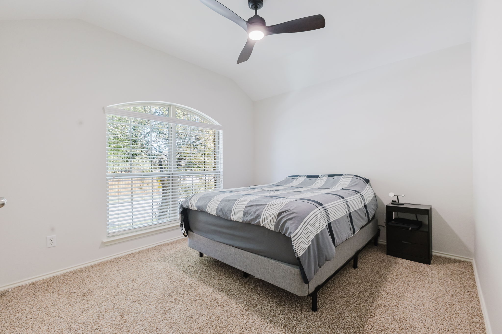 2292 Intrepid Drive Buda, TX 78610 - Photo 12 of 38 Bedroom featuring lofted ceiling, ceiling fan, and light carpet