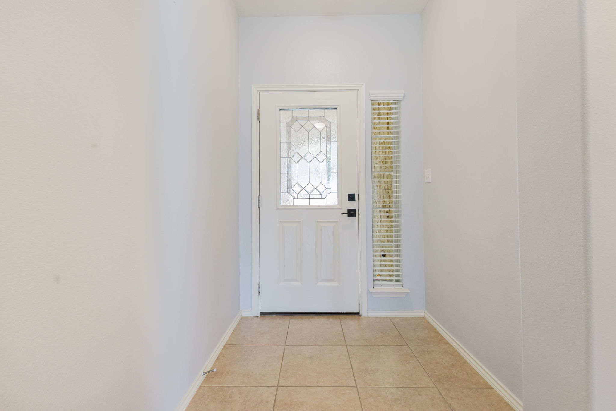 2292 Intrepid Drive Buda, TX 78610 - Photo 17 of 38 Foyer featuring light tile patterned floors and baseboards