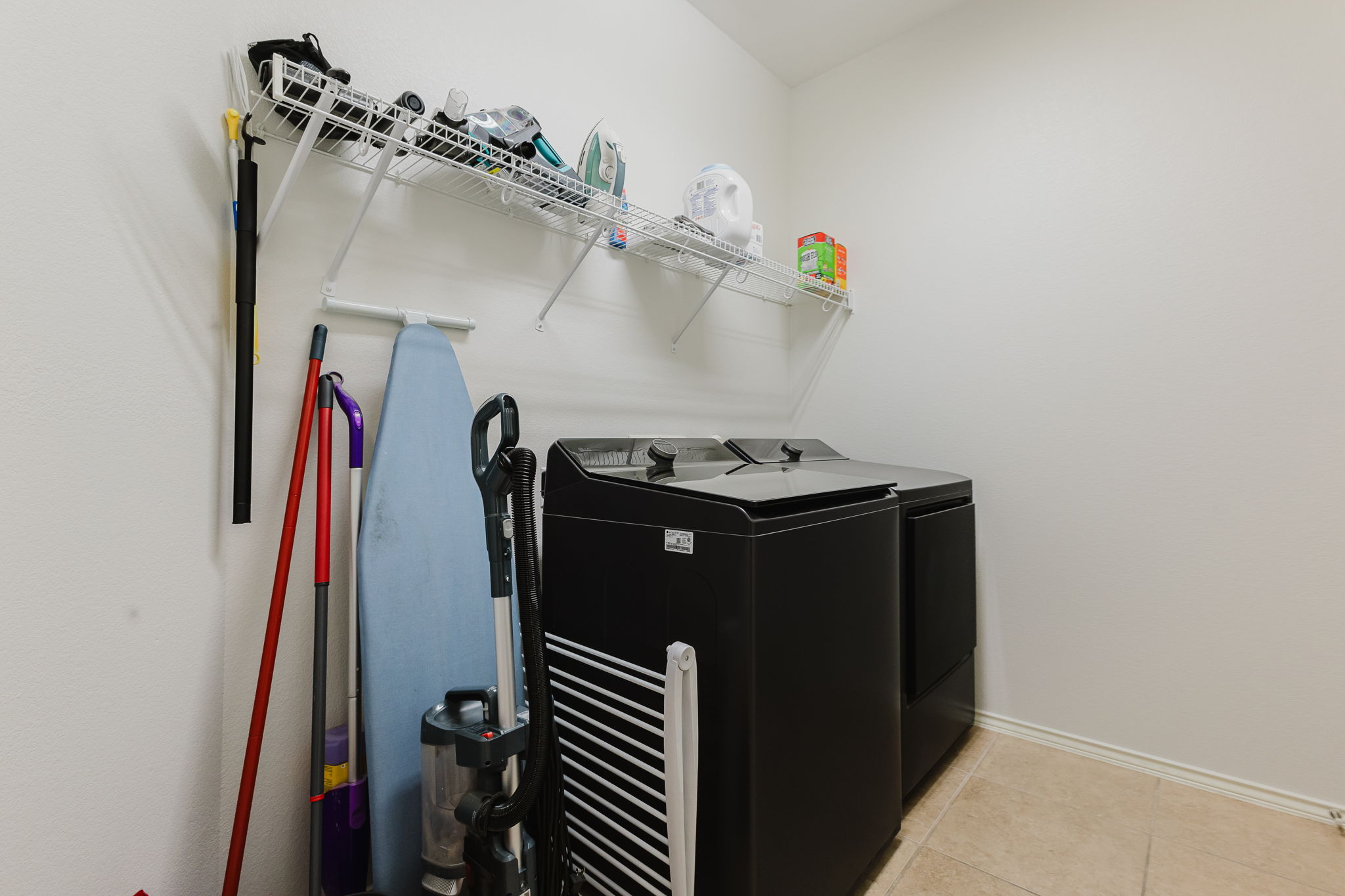 2292 Intrepid Drive Buda, TX 78610 - Photo 18 of 38 Laundry area featuring light tile patterned floors and independent washer and dryer