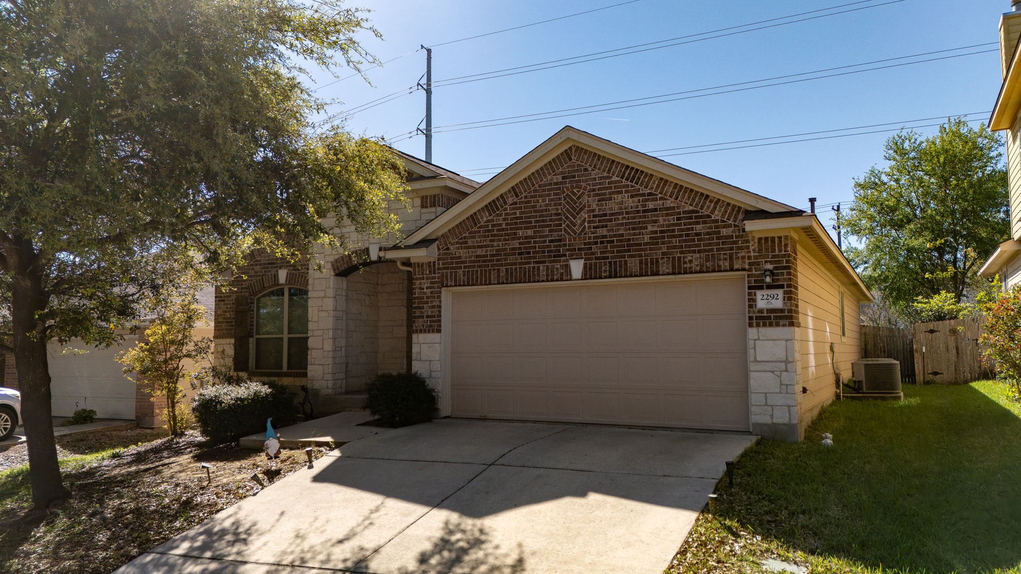 2292 Intrepid Drive Buda, TX 78610 - Photo 30 of 38 View of front of home featuring a garage, concrete driveway, stone siding, and brick siding