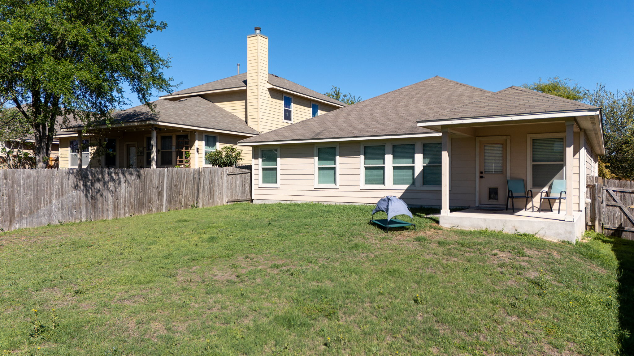 2292 Intrepid Drive Buda, TX 78610 - Photo 36 of 38 Rear view of property featuring a fenced backyard, a patio area, roof with shingles, and a chimney