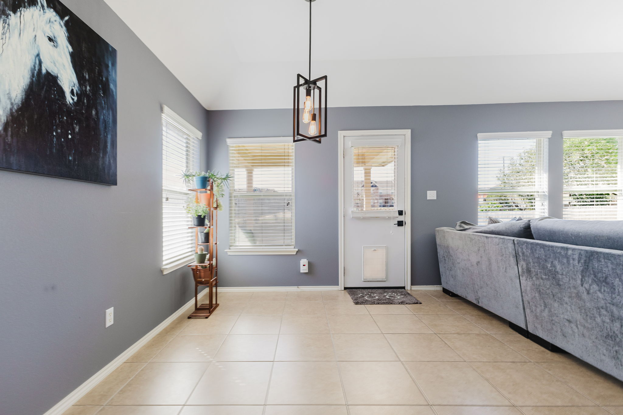 2292 Intrepid Drive Buda, TX 78610 - Photo 6 of 38 Foyer entrance featuring light tile patterned floors, lofted ceiling, and suspended lighting