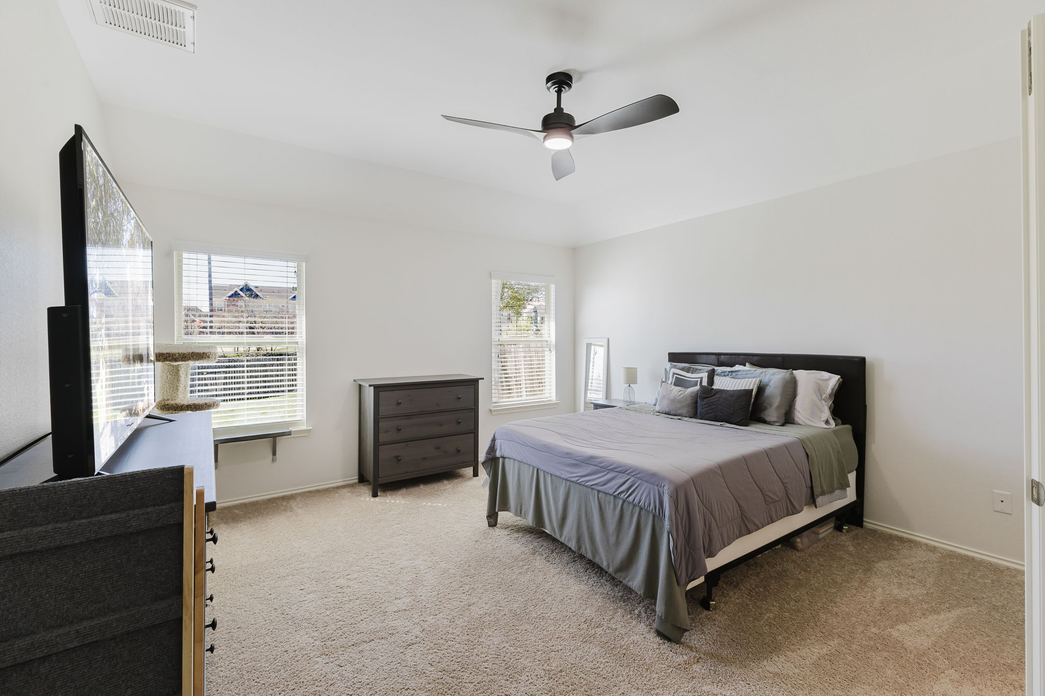 2292 Intrepid Drive Buda, TX 78610 - Photo 7 of 38 Bedroom with light colored carpet and a ceiling fan