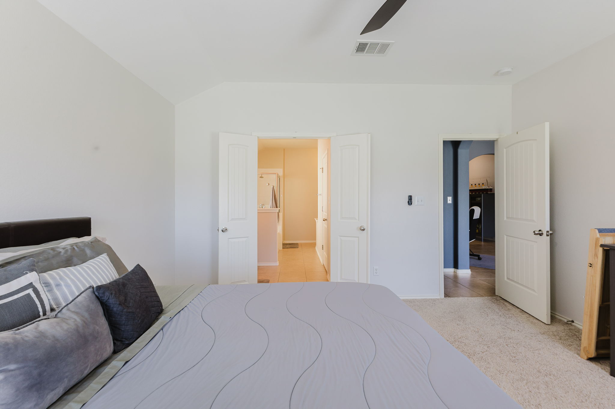 2292 Intrepid Drive Buda, TX 78610 - Photo 9 of 38 Bedroom with light carpet, lofted ceiling, and ceiling fan