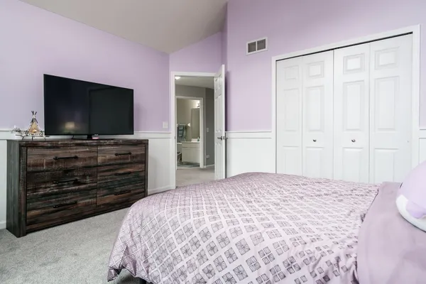 a kitchen with stainless steel appliances a stove a sink a microwave a refrigerator a stove and white cabinets