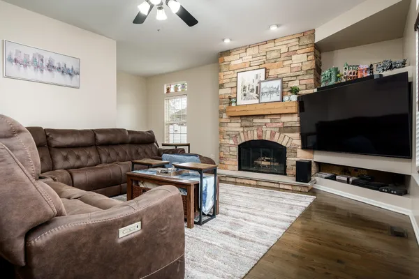 a living room with furniture a flat screen tv and a fireplace