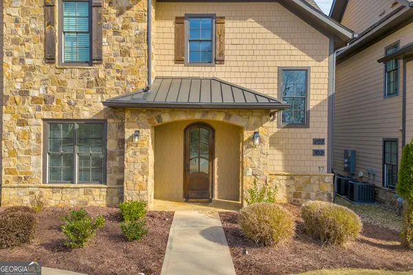 a front view of a house with a garden