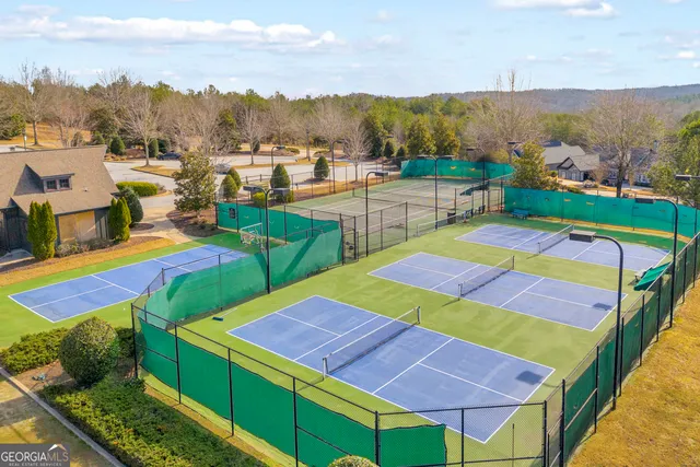 a front view of a house with a garden and tree