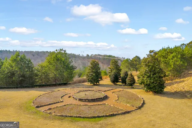 a front view of a house with yard and dining table