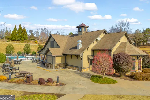 a view of center island a sink a flat screen tv and a couch