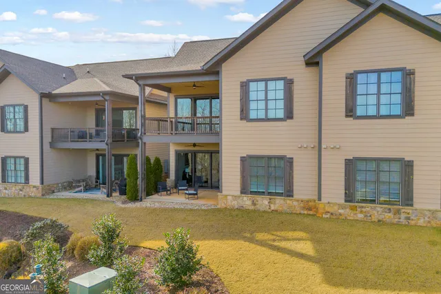 a living room with furniture a flat screen tv and a large window