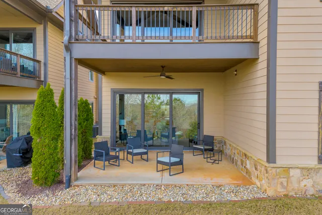 a living room with furniture kitchen view and a window