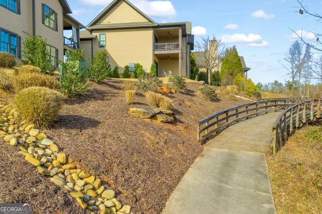 a living room with furniture and a view of kitchen