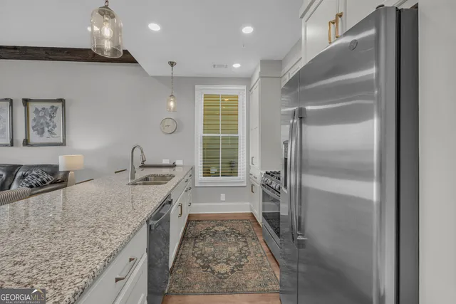 a spacious bathroom with a granite countertop sink a mirror and shower