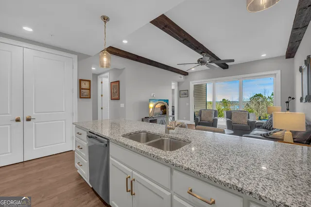 a bedroom with a bed a window and a flat screen television