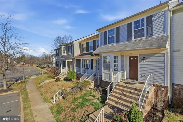 a front view of a house with a yard table and chairs