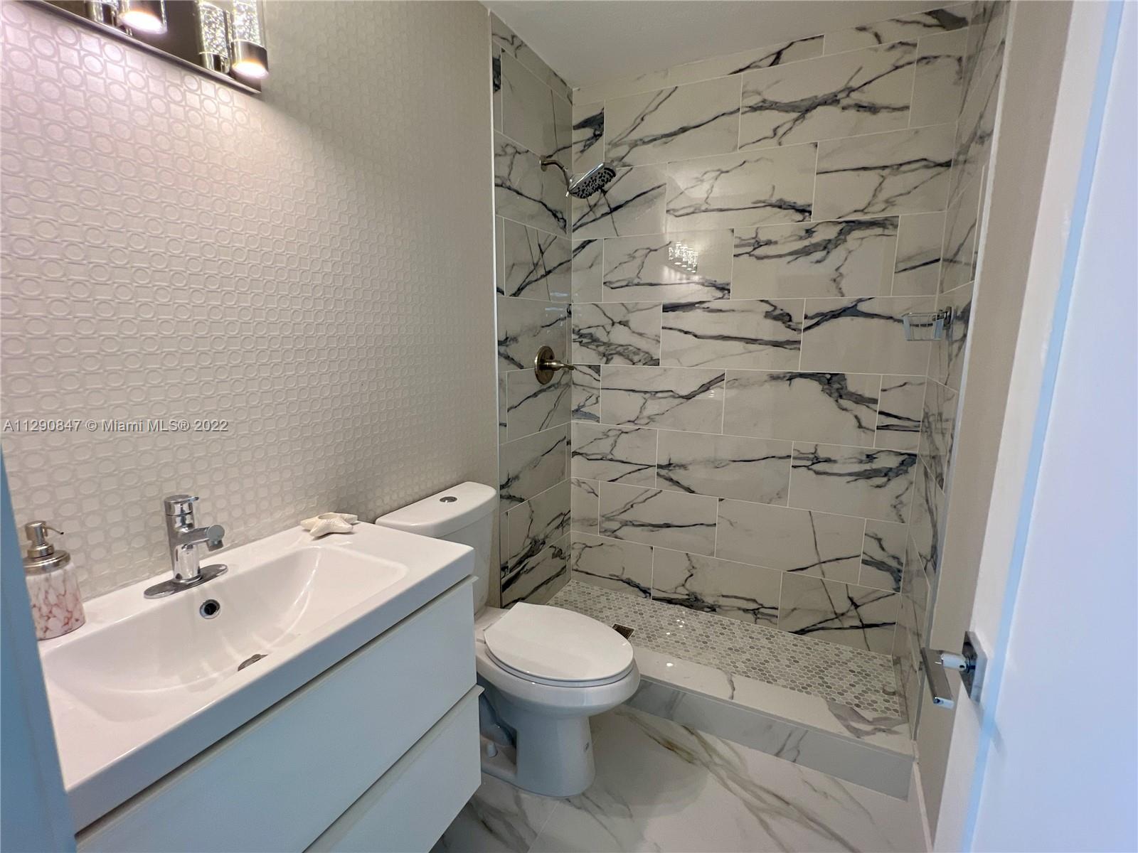 17841 Southwest 113th Avenue Miami, FL 33157 - Photo 14 of 20 a bathroom with a sink toilet and shower