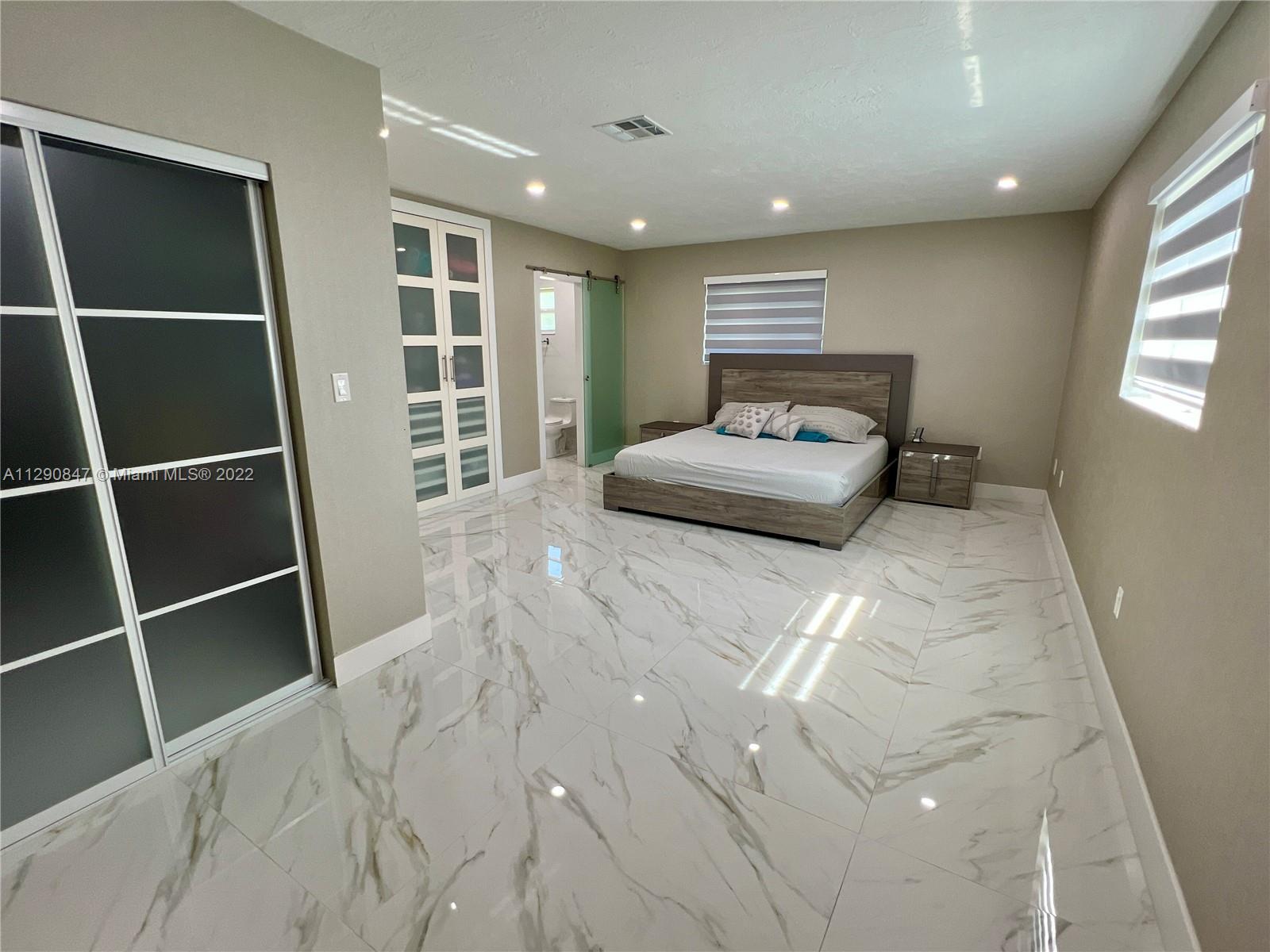 17841 Southwest 113th Avenue Miami, FL 33157 - Photo 2 of 20 a bedroom with a bed and window