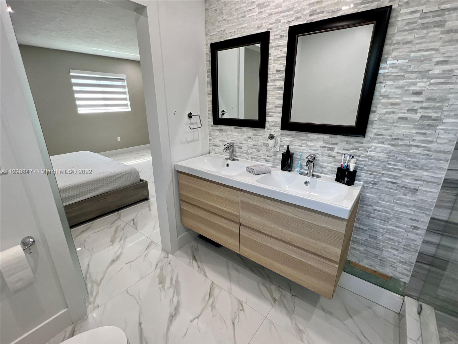 17841 Southwest 113th Avenue Miami, FL 33157 - Photo 4 of 20 a bathroom with a sink and a mirror