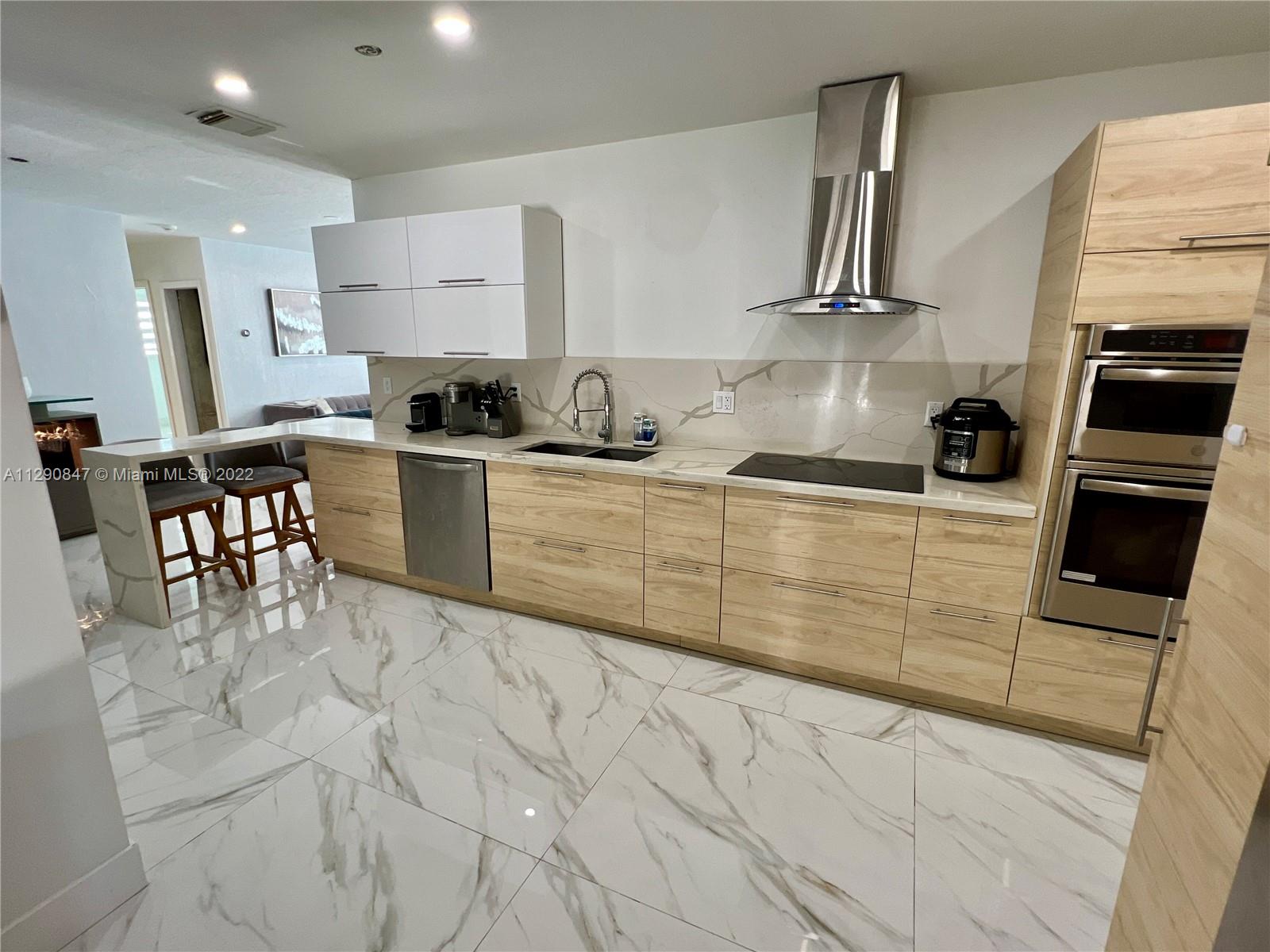 17841 Southwest 113th Avenue Miami, FL 33157 - Photo 6 of 20 a kitchen with stainless steel appliances kitchen island granite countertop a sink and cabinets