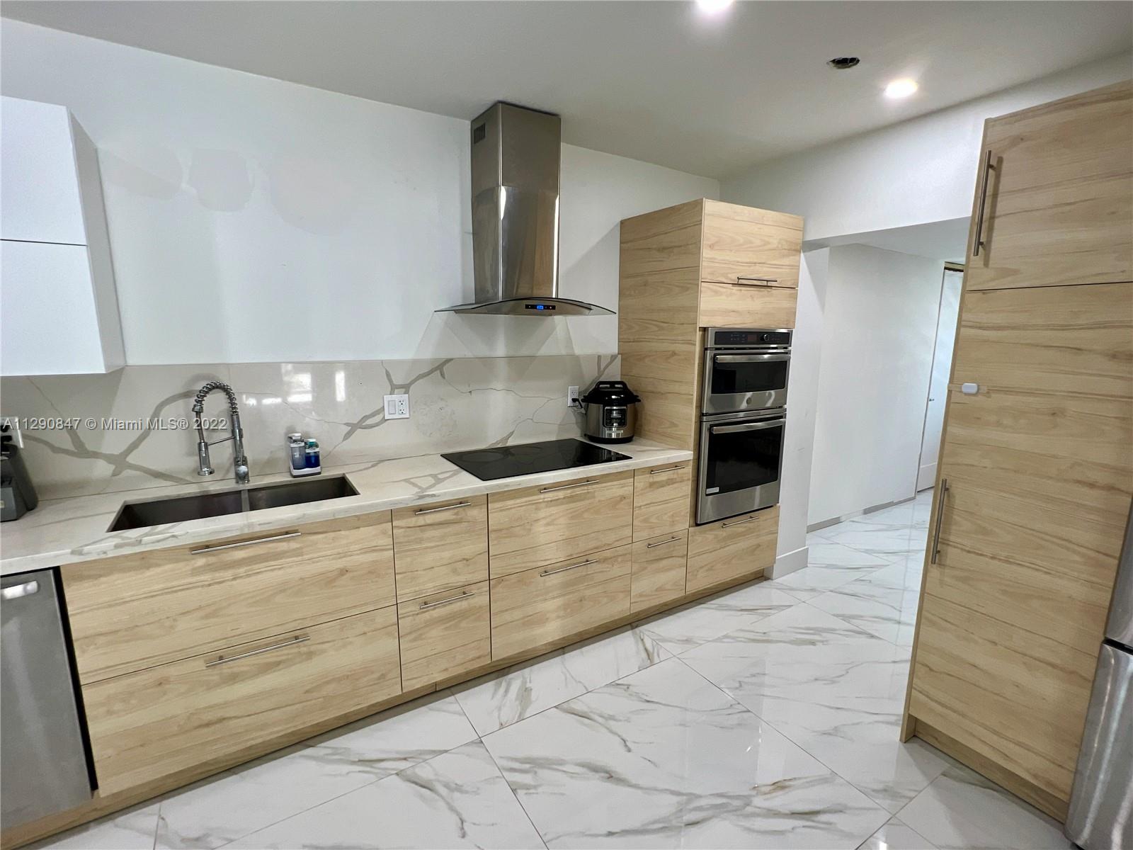 17841 Southwest 113th Avenue Miami, FL 33157 - Photo 7 of 20 a kitchen with granite countertop a sink and cabinets