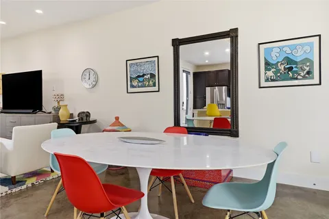 a dining room with furniture and wooden floor