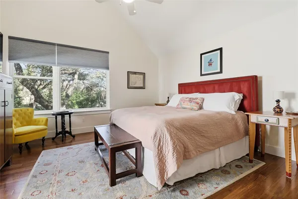 a bedroom with a bed a couch and a window