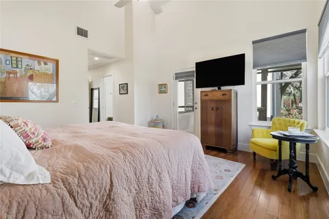 a bedroom with a bed and a flat screen tv