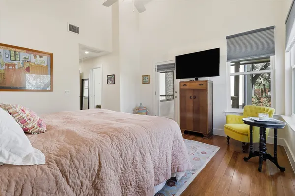 a bedroom with a bed and a flat screen tv