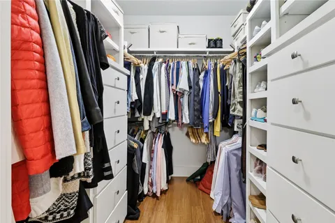a view of walk in closet with clothes
