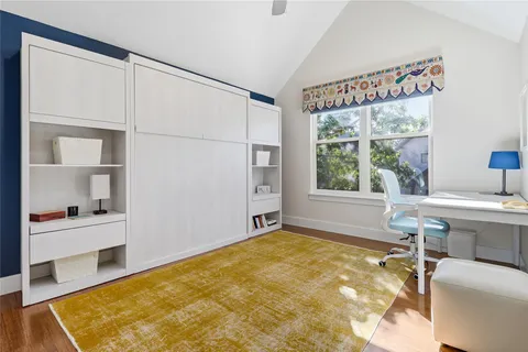 a spacious bedroom with a bed and a window