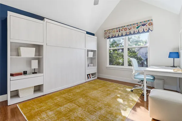 a spacious bedroom with a bed and a window