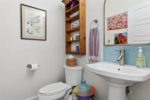 a bathroom with a sink mirror and toilet