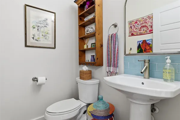 a bathroom with a sink mirror and toilet