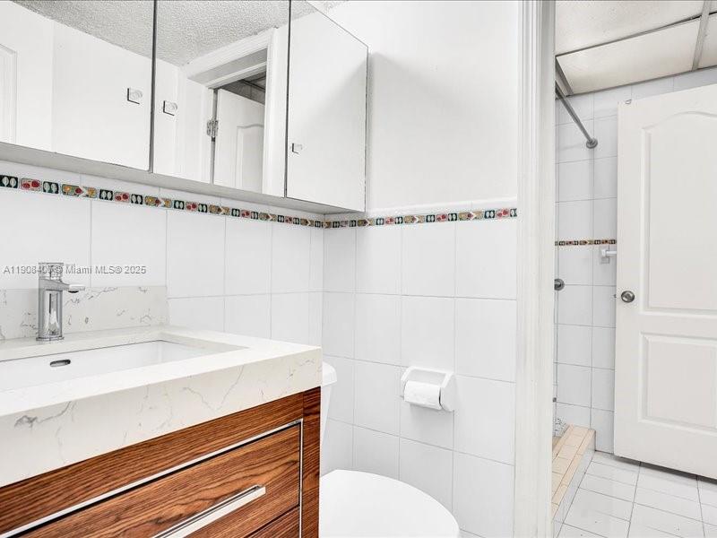 8990 Southwest 24th Street, Unit 33 Miami, FL 33165 - Photo 11 of 22 a bathroom with a sink a toilet and shower