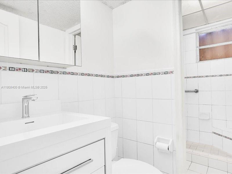 8990 Southwest 24th Street, Unit 33 Miami, FL 33165 - Photo 15 of 22 a bathroom with a sink and a mirror