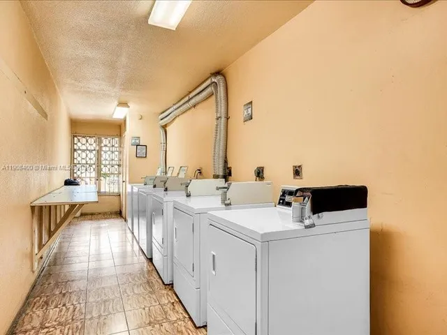 a view of washer and dryer with a kitchen view