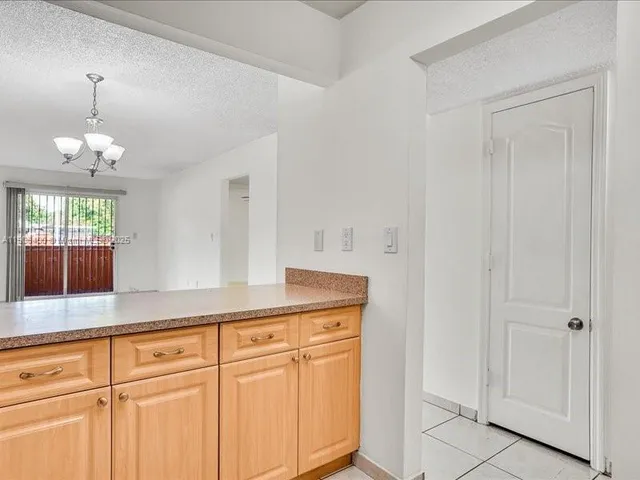 a hallway with sink and mirror