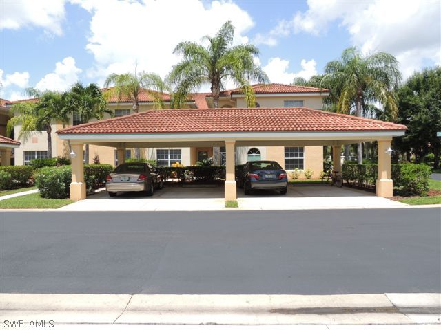 23891 Costa Del Sol Road, Unit 103 Bonita Springs, FL 34135 - Photo 1 of 12 a car parked in front of a building