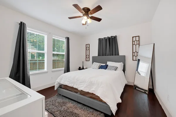 a bedroom with a bed and a large window