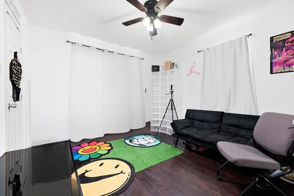 a living room with furniture and a wooden floor