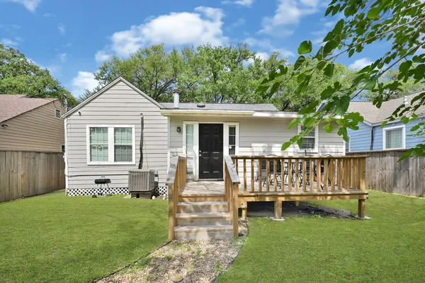a view of a house with a yard and deck