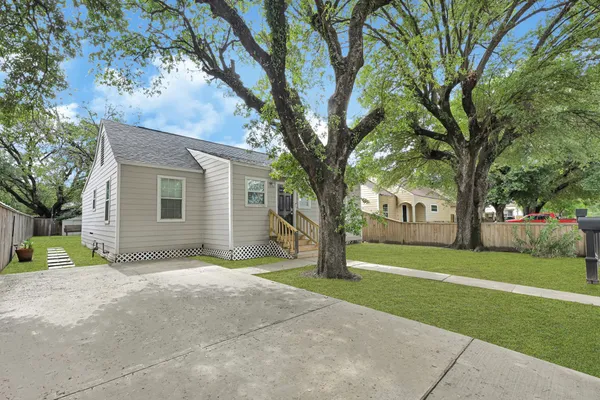 a view of a house with a tree in front of it