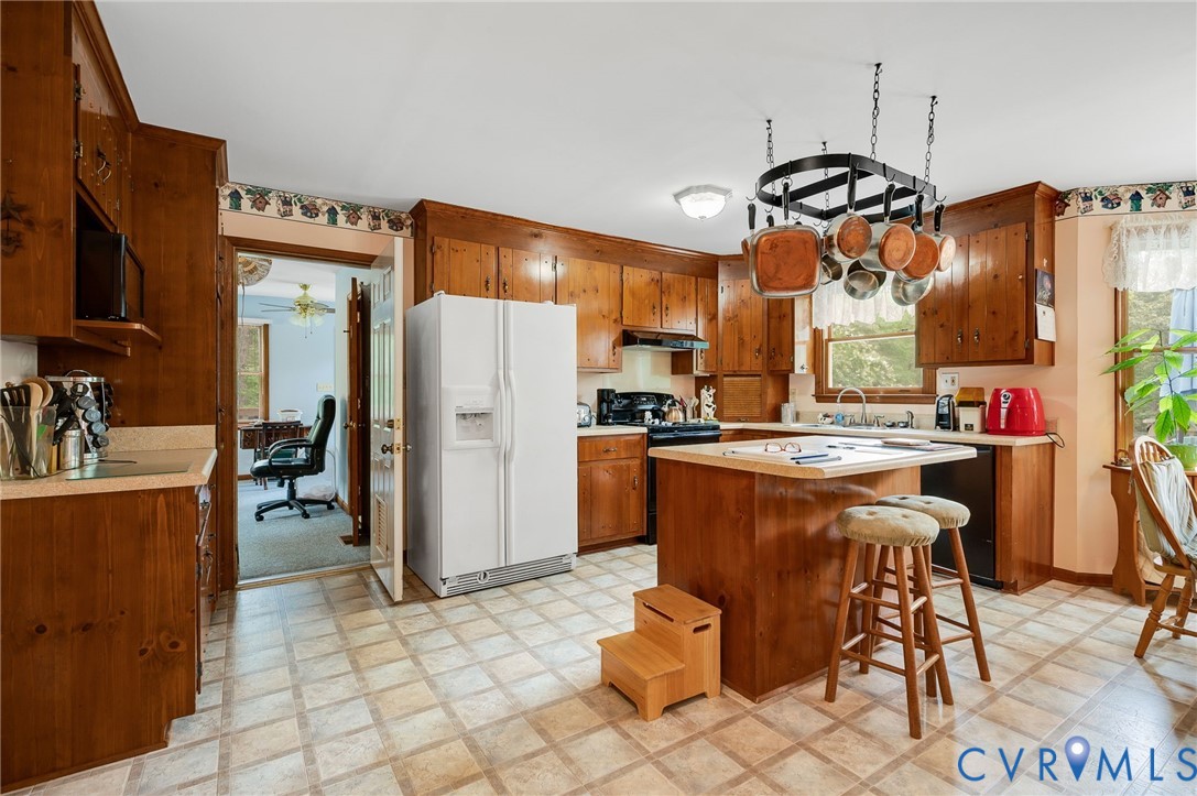 17707 Loving Union Road Disputanta, VA 23842 - Photo 12 of 42 Kitchen featuring wood cabinetry, a central island