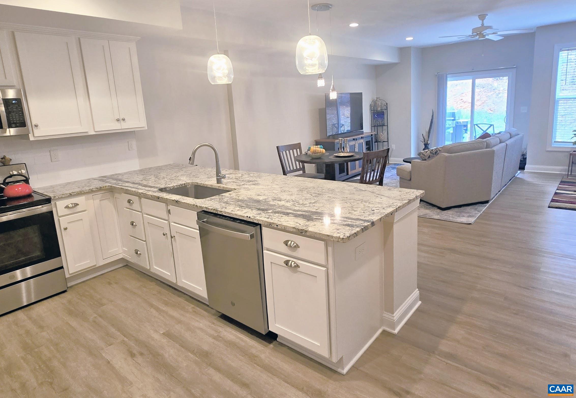 104 Blithe Court Charlottesville, VA 22901 - Photo 1 of 11 a kitchen that has a sink a stove counter space and a wooden floor