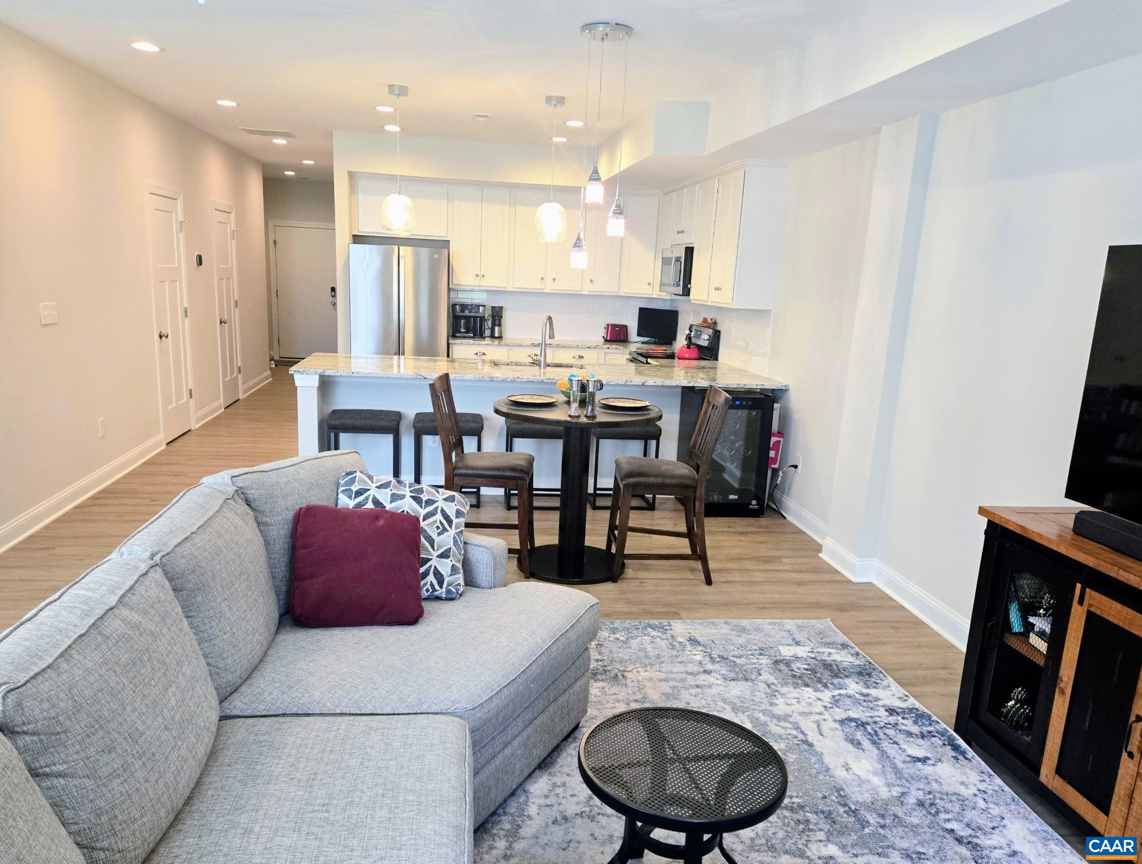 104 Blithe Court Charlottesville, VA 22901 - Photo 5 of 11 a living room with stainless steel appliances granite countertop furniture a rug and a view of kitchen