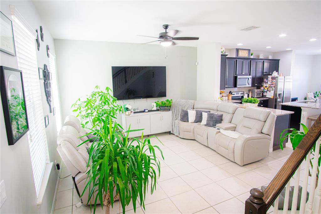11636 Water Run Alley Windermere, FL 34786 - Photo 4 of 18 a living room with furniture a chandelier and a flat screen tv