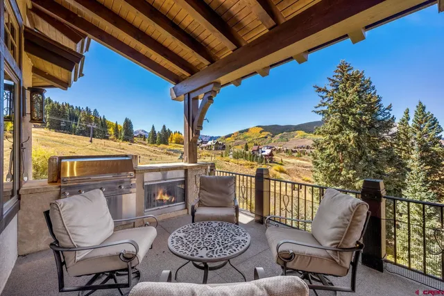 a view of a chairs and table in the balcony