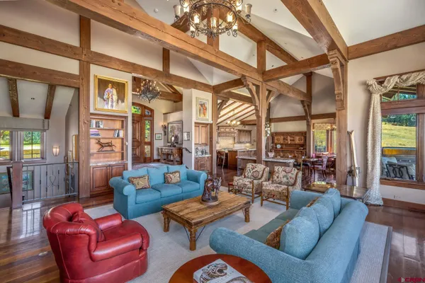 a living room with furniture a fireplace and a chandelier